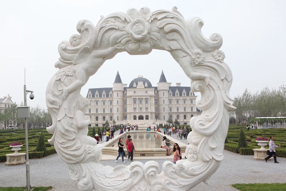 A European-style building is seen through a stone ring at the opening of the Ninth China (Beijing) International Garden Expo on Saturday, May 18, 2013. The expo will last for six months. [Photo: CRIENGLISH.com / Luo Dan]