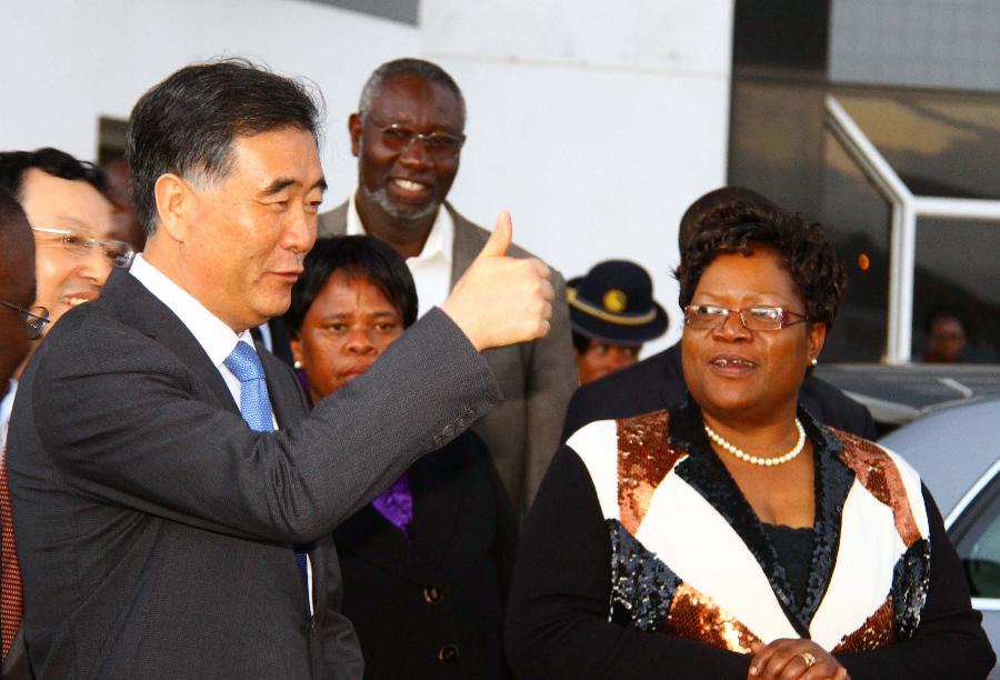 Chinese Vice Premier Wang Yang (L, front) gestures upon his arrival as Zimbabwe's Vice President Joyce Mujuru (R) is seen in Harare, Zimbabwe, on May 21, 2013. Wang Yang arrived in Harare on Tuesday, starting an official visit to Zimbabwe, the first leg of his African trip from May 21 to 25 to boost China's relations with the continent. (Xinhua/Wang Yue)