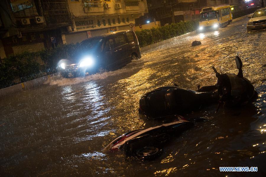 Vehicles run in rain on a waterlogged road in Macao, south China, May 22, 2013. (Xinhua/Cheong Kam Ka)