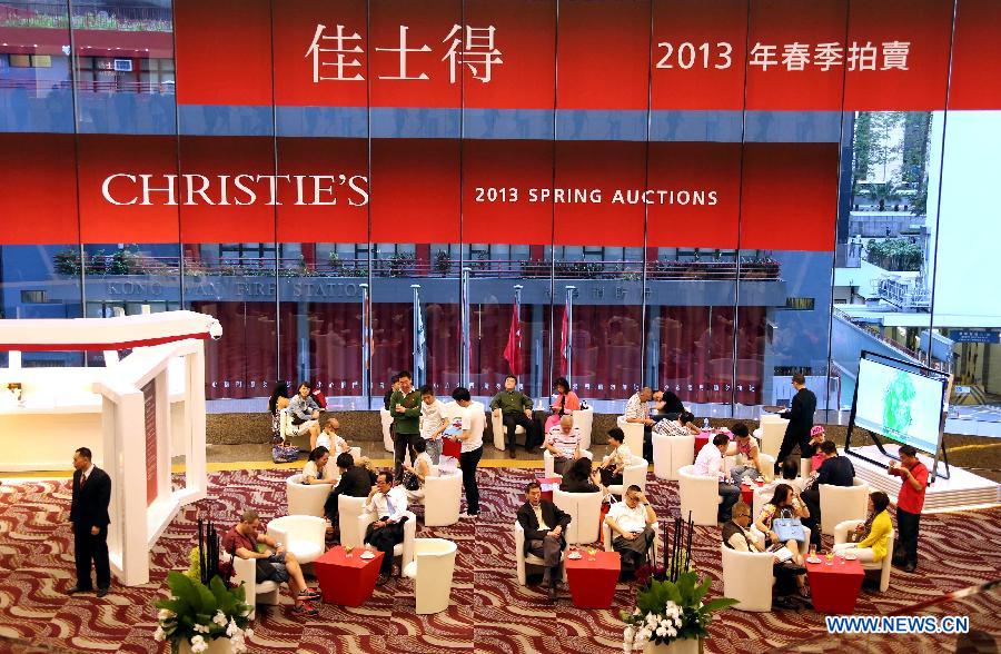Visitors rest at the preview of the Christie's 2013 spring auctions in south China's Hong Kong, May 24, 2013. The five-day auctions begin on May 25. (Xinhua/Li Peng)