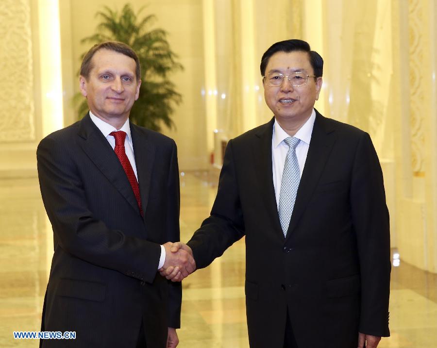 Zhang Dejiang (R), chairman of the Standing Committee of the National People's Congress of China, shakes hands with Sergei Naryshkin, chairman of the State Duma, the lower house of the Russian parliament, before their talks in Beijing, capital of China, May 27, 2013. (Xinhua/Ding Lin)  