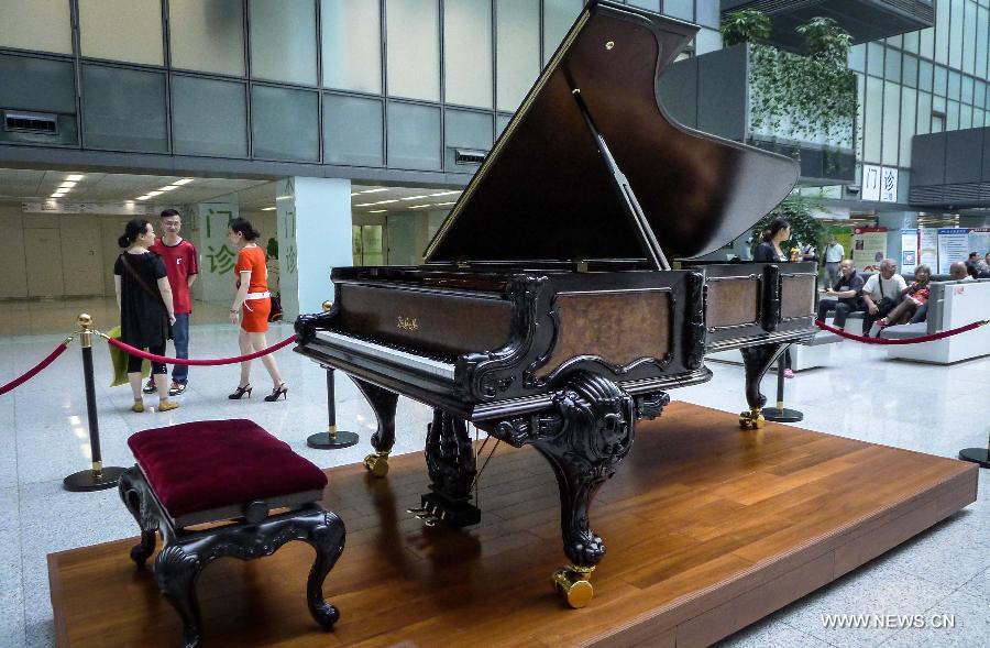 Photo taken on May 21, 2013 shows a piano made by Zhang Gangning, a piano maker, is displayed at the lobby of Gulou Hospital in Nanjing, capital of east China's Jiangsu Province.  (Xinhua/Yang Lei)