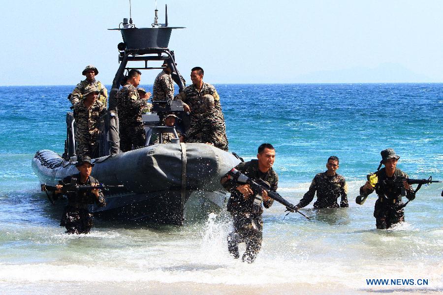 Philippine Military Academy (PMA) cadets take positions ashore during a joint field training exercise at the Marines' training centre in Cavite Province, the Philippines, May 29, 2013. More than 700 future military officers in the Philippines went through drills at a marine base for joint training on land, air, and sea assault after seven marine soldiers were killed in action in a clash against Islamist militant members of the al-Qaeda-linked Abu Sayyaf in Patikul town in Sulu, southern Philippines on May 25. (Xinhua/Rouelle Umali) 