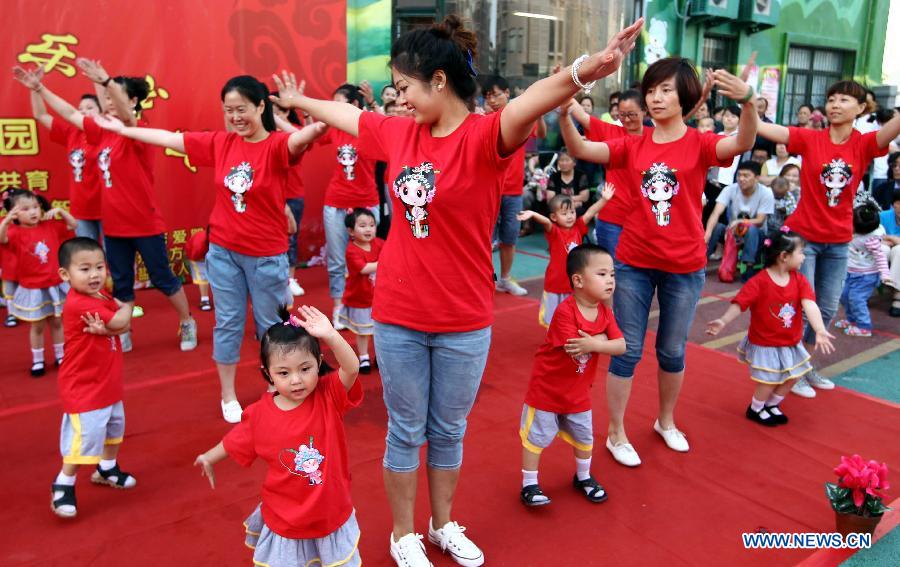 Children dance with their parents at the Dongfang Kindergarten in a celebration for the forthcoming International Children's Day in Yuncheng City, north China's Shanxi Province, May 29, 2013. (Xinhua/Xue Jun)