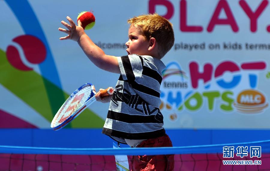 A three-year-old fun learns to play tennis in Melbourne, Australia, Jan. 23, 2012. (Photo/Xinhua)