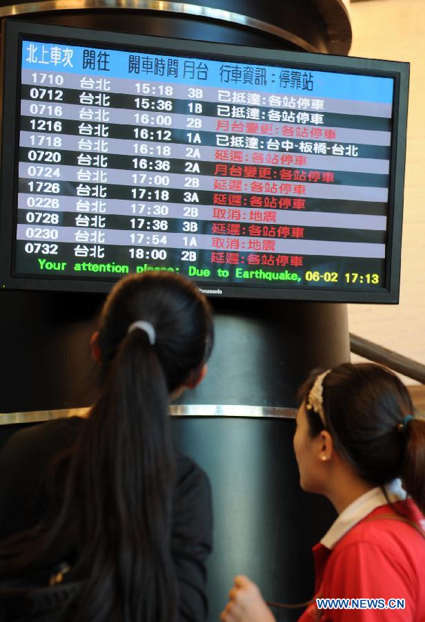 Passengers look at information of trains in Kaohsiung, southeast China's Taiwan, June 2, 2013. High-speed rails in Taiwan were delayed or canceled due to the earthquake which struck Taiwan's Nantou County Sunday afternoon. A 6.7-magnitude earthquake jolted Nantou County, South of Taiwan on Jun. 2, 2013, leaving 2 dead and 21 injured. (Xinhua/Tao Ming) 