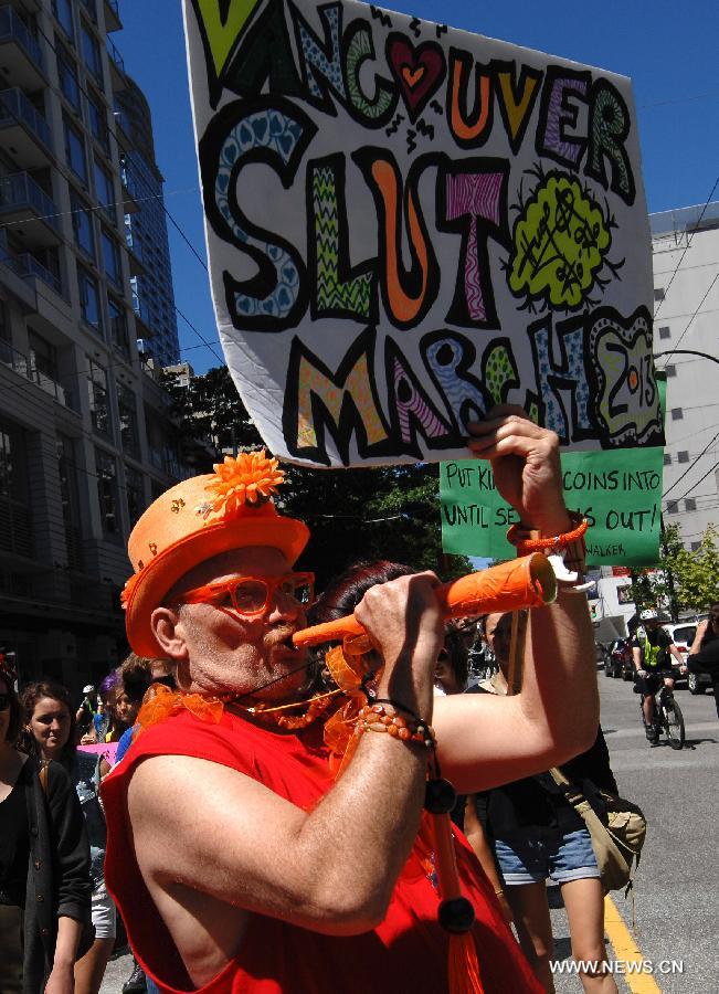 Participants march during a 2013 SlutWalk rally against sexual discrimination or inequality in Vancouver, Canada, on June 2, 2013. Slutwalk is a movement across the world, calling for equal rights for sex and genders' respect, which was provoked after a policeman advised young women to "avoid dressing like sluts" in Canada in April 2011. (Xinhua/Sergei Bachlakov) 