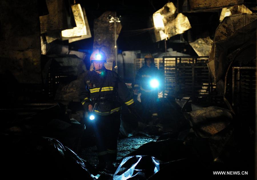 Fire fighters search for survivors at the burnt poultry slaughterhouse owned by the Jilin Baoyuanfeng Poultry Company in Mishazi Township of Dehui City in northeast China's Jilin Province, June 3, 2013. The death toll from the fire has risen to 119 as of 8 p.m. on Monday. Search and rescue work is under way. (Xinhua/Xu Chang)