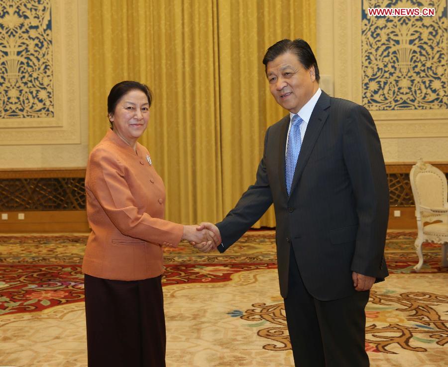 Liu Yunshan (R), a member of the Standing Committee of the Political Bureau of the Communist Party of China Central Committee, meets with Pany Yathotou, president of the Laotian National Assembly, in Beijing, capital of China, June 4, 2013. (Xinhua/Liu Weibing)