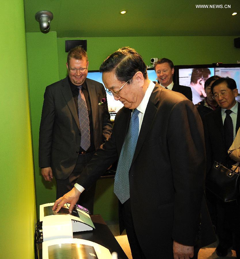 Yu Zhengsheng (front), chairman of the National Committee of the Chinese People's Political Consultative Conference, visits Ericsson company, in Stockholm, Sweden, June 4, 2013. (Xinhua/Liu Jiansheng) 