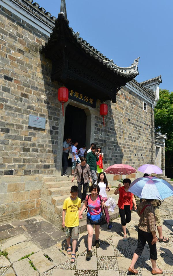Tourists visit a traditional customs museum at the Mount Phoenix scenic area in Zigui county, Hubei province, June 2, 2013. (Xinhua)