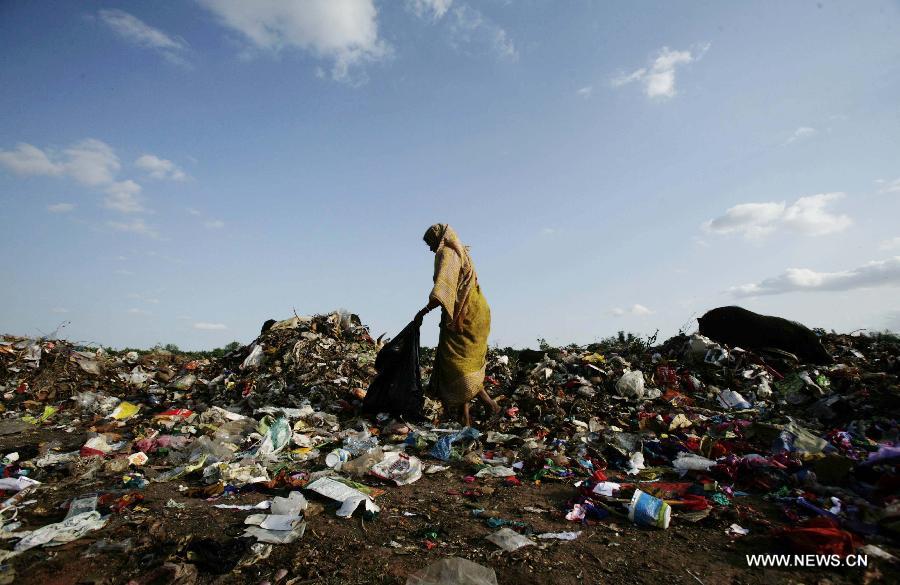An Indian rag picker searches for reusable materials at a municipality dumping yard on the eve of the World Environment Day on the outskirts of the eastern Indian state Orissa's Bhubaneswar, June 4, 2013. The World Environment Day that falls on June 5 is celebrated by the United Nations to stimulate worldwide awareness of environmental issues and encourages political actions. (Xinhua/Stringer)