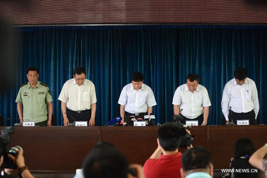 Spokesmen of relevant government departments concerning health, environment, safety supervision and fire fighting mourn for the victims of a fire accident at a press conference in Changchun, capital of northeast China's Jilin Province, June 6, 2013. A fire broke out at a poultry processing workshop owned by the Jilin Baoyuanfeng Poultry Company in Mishazi Township in the city of Dehui in Jilin on early Monday morning. The fire killed 120 people and injured 77 others. (Xinhua/Lin Hong)