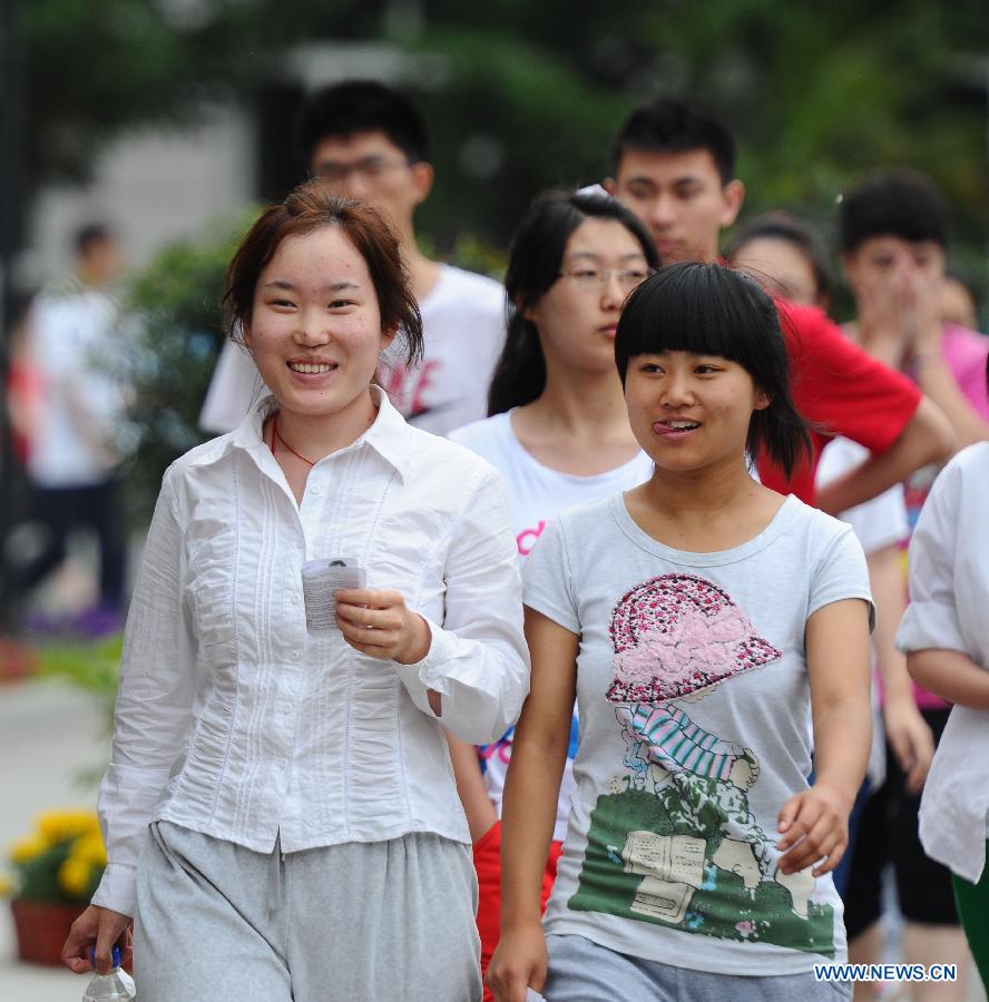 Examinees walk out of the exam site after the first test of the national college entrance exam at the No. 11 High School in Changchun, capital of northeast China's Jilin Province, June 7, 2013. Some 9.12 million applicants are expected to sit this year's college entrance exam on June 7 and 8. (Xinhua/Xu Chang)