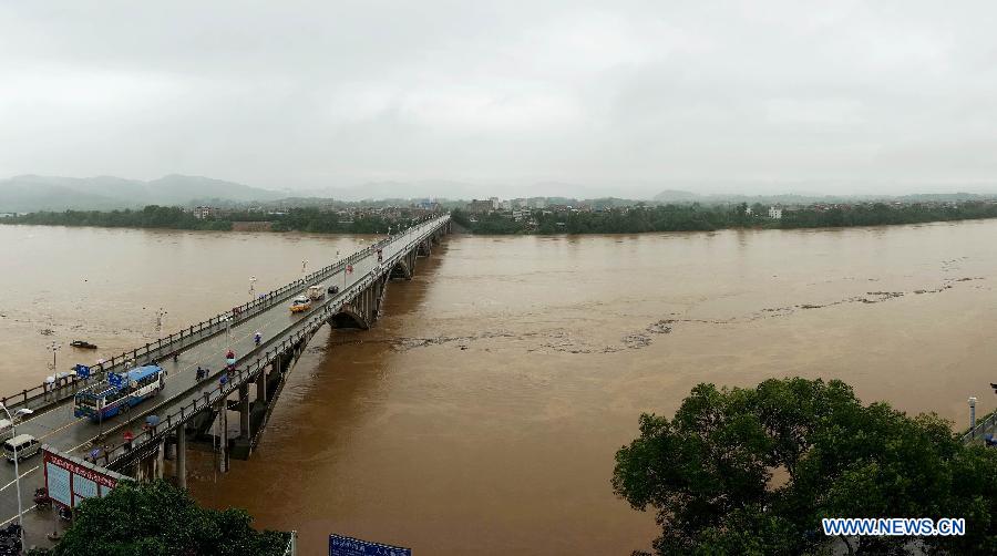Photo taken on June 9, 2013 shows a flooded river in Rongshui Miao Autonomous County, south China's Guangxi Zhuang Autonomous Region. Heavy rains have hit the county since June 8, triggering floods and disrupting traffic and telecommunications in some areas. (Xinhua/Long Tao) 