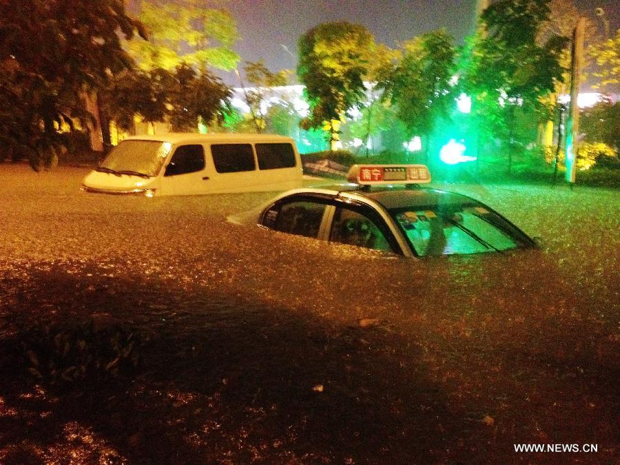 Vehicles are submerged in the flood water at a community in Nanning City, capital of south China's Guangxi Zhuang Autonomous Region June 9, 2013. A thunder storm hit Nanning Sunday night, causing floods in many regions of the city. (Xinhua/Xiang Zhiqiang) 