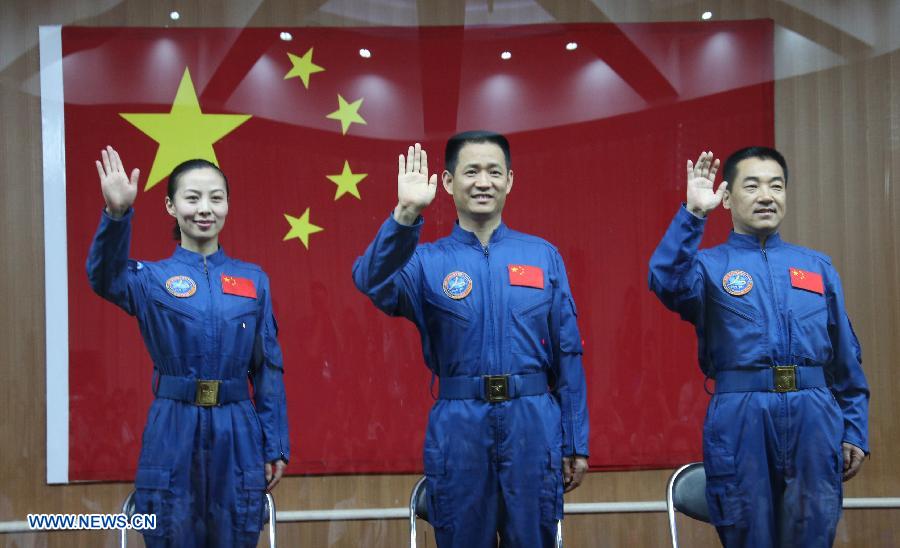 The three astronauts of the Shenzhou-10 manned spacecraft mission, Nie Haisheng (C), Zhang Xiaoguang (R) and Wang Yaping, meet the media at the Jiuquan Satellite Launch Center in Jiuquan, northwest China's Gansu Province, June 10, 2013. The Shenzhou-10 manned spacecraft will be launched at the Jiuquan Satellite Launch Center at 5:38 p.m. Beijing Time (0938 GMT) June 11. (Xinhua/Wang Jianmin)