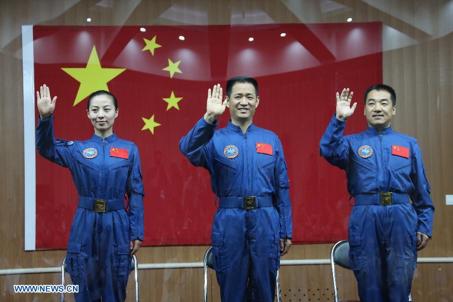 The three astronauts of the Shenzhou-10 manned spacecraft mission, Nie Haisheng (C), Zhang Xiaoguang (R) and Wang Yaping, meet the media at the Jiuquan Satellite Launch Center in Jiuquan, northwest China's Gansu Province, June 10, 2013. The Shenzhou-10 manned spacecraft will be launched at the Jiuquan Satellite Launch Center at 5:38 p.m. Beijing Time (0938 GMT) June 11. (Xinhua/Wang Jianmin)
