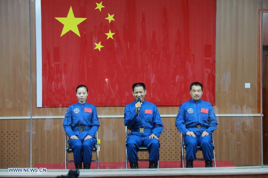 Nie Haisheng (C), one of the three astronauts of the Shenzhou-10 manned spacecraft mission, answers a question as meeting the media at the Jiuquan Satellite Launch Center in Jiuquan, northwest China's Gansu Province, June 10, 2013. The Shenzhou-10 manned spacecraft will be launched at the Jiuquan Satellite Launch Center at 5:38 p.m. Beijing Time (0938 GMT) June 11. (Xinhua/Li Gang)