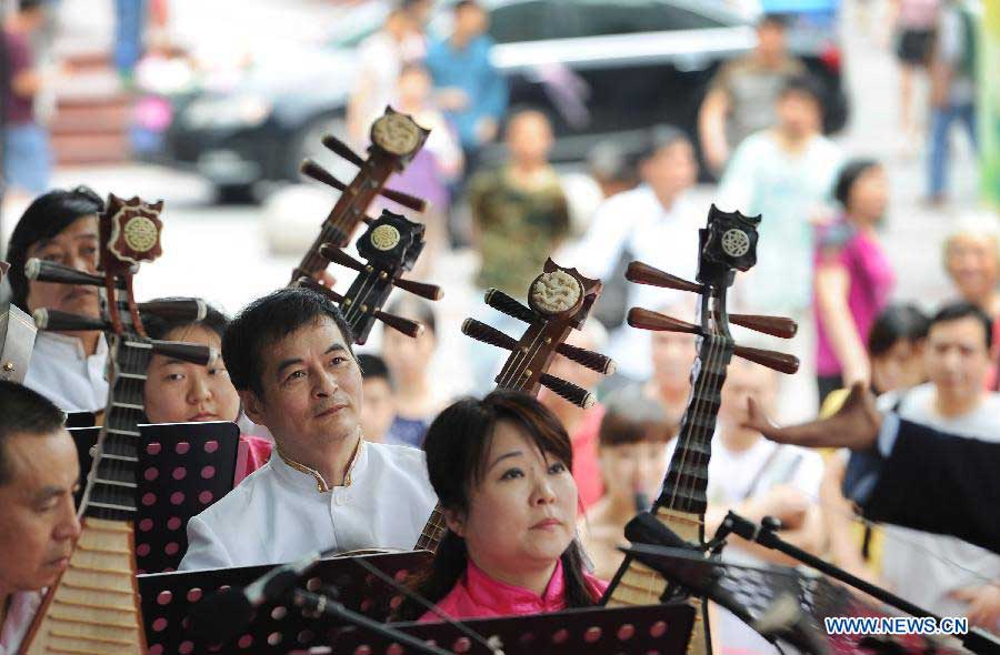 A concert is held during the Dragon Boat (Duanwu) Festival holiday in Chongqing, southwest China, June 10, 2013. The Duanwu Festival, which is celebrated across China to pay homage to Qu Yuan, a patriotic poet during the Warring State Period (475-221 BC), falls on the fifth day of the fifth month in the Chinese lunar calendar, or June 12 this year. (Xinhua/Chen Cheng) 