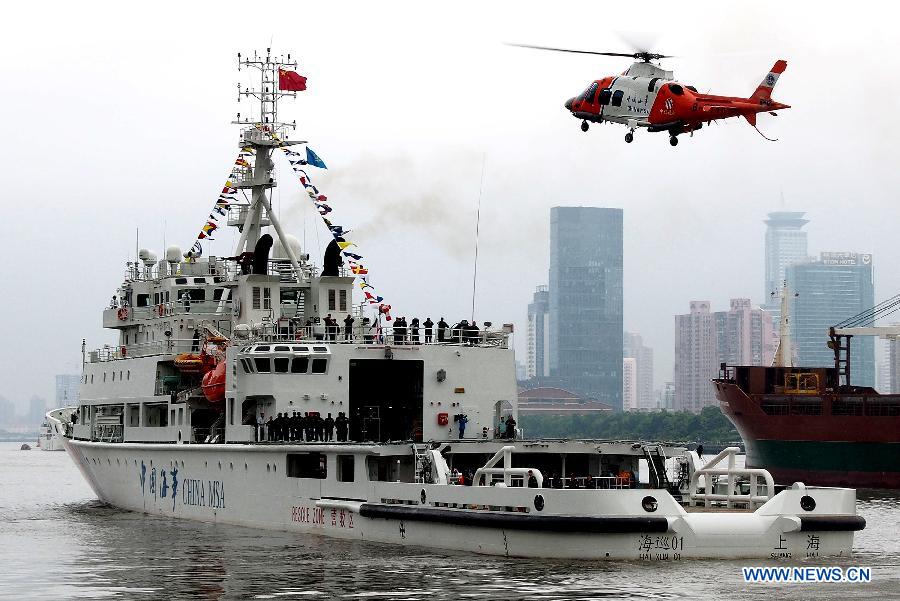 A helicopter and its support ship "Haixun 01" of China's Maritime Safety Administration (MSA) leaves Shanghai, east China, June 10, 2013. The public service ship will conduct a 62-day voyage to visit Australia, Indonesia, Myanmar and Malaysia. (Xinhua/Chen Fei)