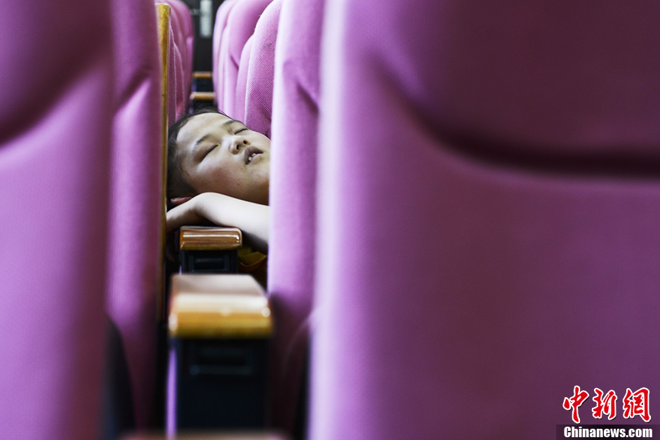 A child falls asleep during the exercise break. (Chinanews/Zhang Yuan)