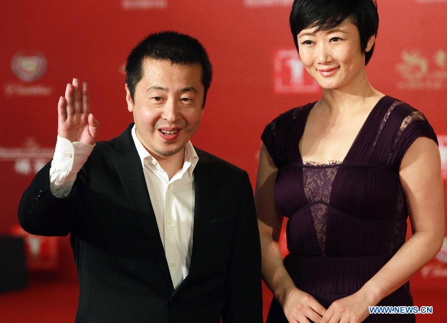 Director Jia Zhangke (L) poses on the red carpet for the opening ceremony of the 16th Shanghai International Film Festival in Shanghai, east China, June 15, 2013. (Xinhua/Ren Long) 