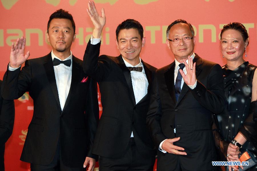Director Johnny To (2nd R), actors Andy Lau (3rd R) and Guo Tao (1st L) pose on the red carpet for the opening ceremony of the 16th Shanghai International Film Festival in Shanghai, east China, June 15, 2013. (Xinhua/Ren Long)