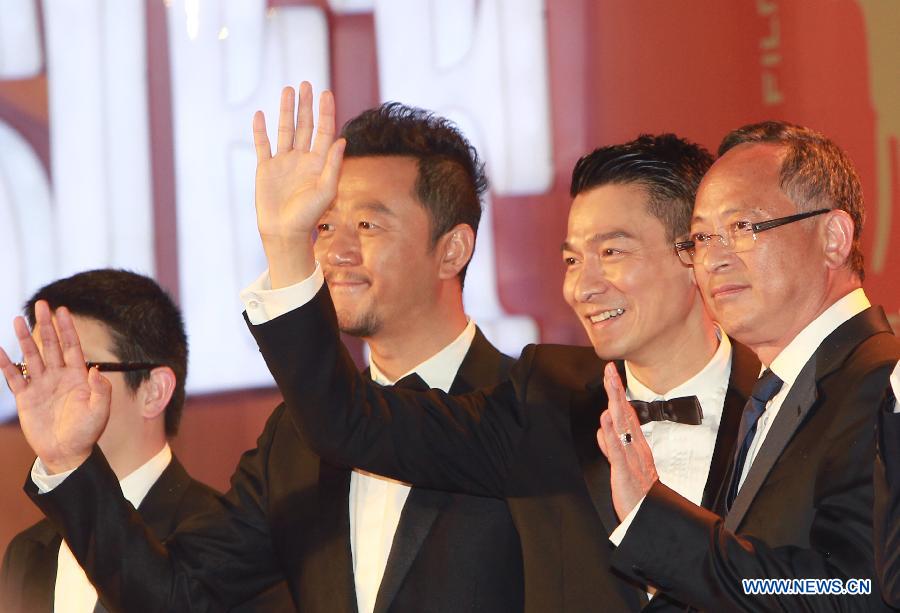 Director Johnny To, actors Andy Lau and Guo Tao (R-L) greets audience on the red carpet for the opening ceremony of the 16th Shanghai International Film Festival in Shanghai, east China, June 15, 2013. (Xinhua/Pei Xin)