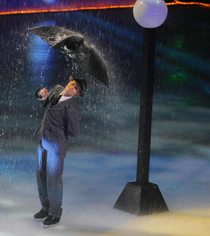 Canadian figure skater and four-time World Champion Kurt Browning performs singing in the Rain in Artistry on Ice, an international art gala founded in 2010, in Guangzhou, south China’s Guangdong province, June 10, 2013. (Xinhua/Wen Hao)
