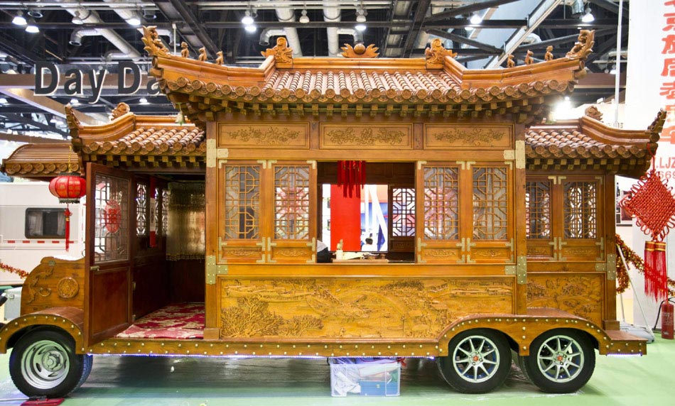 A wooden Chinese style caravan displayed at the 'All in Tuning All in Caravanning' Show China 2013 on June 15, 2013, at the China National Convention Center, Beijing. [Photo / Xinhua]