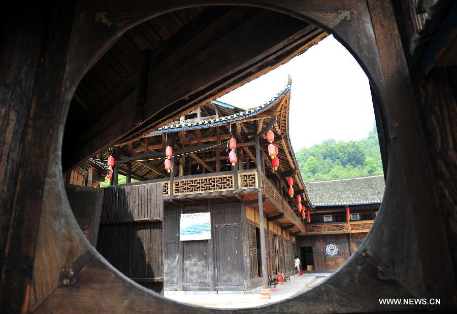 Photo taken on June 16, 2013 shows the wooden Diaojiaolou, or stilted houses in Shiyanping Village, Wangjiaping Township of Zhangjiajie City in central China's Hunan Province. The Shiyanping Village, located in the southeast of Wangjiaping, is one of the regions in Hunan where stilted houses are well preserved. With a toal of 182 existing stilted houses of the Tujia ethnic group, the village was listed as the seventh batch of important heritage sites under state protection in 2013. (Xinhua/Shao Ying)