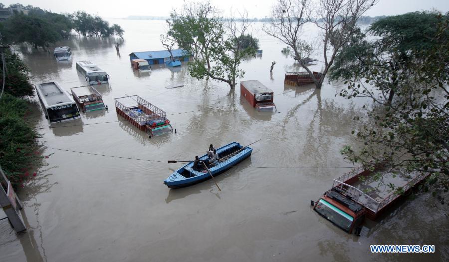 Buses and trucks are submerged in floodwaters of the Yamuna River in New Delhi, India, June 19, 2013. The Indian capital has been put on flood alert after its main Yamuna river breached the danger mark following incessant rainfall since June 16. (Xinhua/Partha Sarkar)