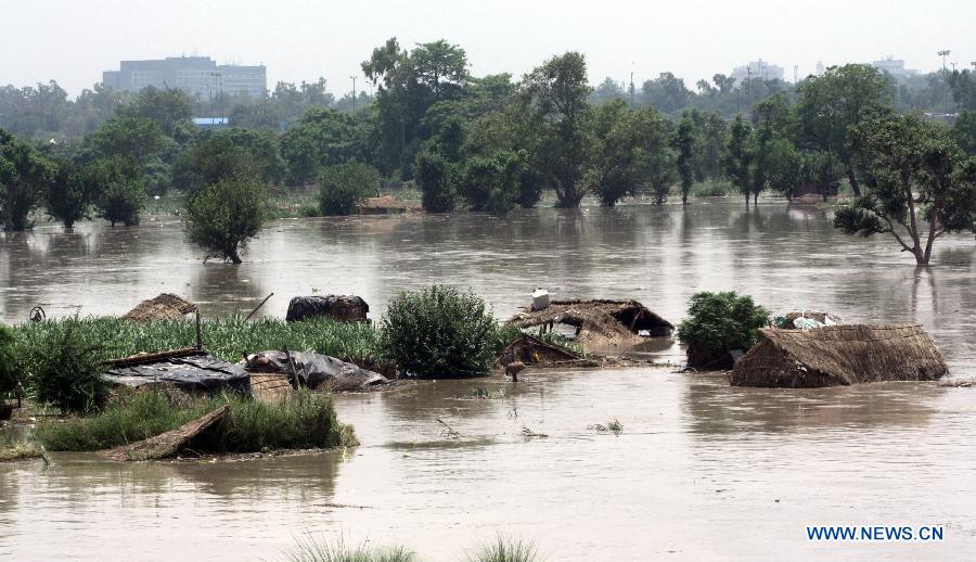 Huts are submerged in floodwaters of the Yamuna River in New Delhi, India, June 19, 2013. The Indian capital has been put on flood alert after its main Yamuna river breached the danger mark following incessant rainfall since June 16. (Xinhua/Partha Sarkar) 