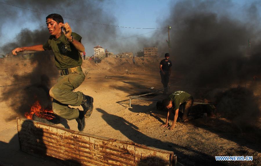 A Palestinian boy takes part in a military exercises during a military graduation ceremony organized by Hamas movement in the southern Gaza Strip city of Rafah on June 19, 2013. (Xinhua/Khaled Omar)