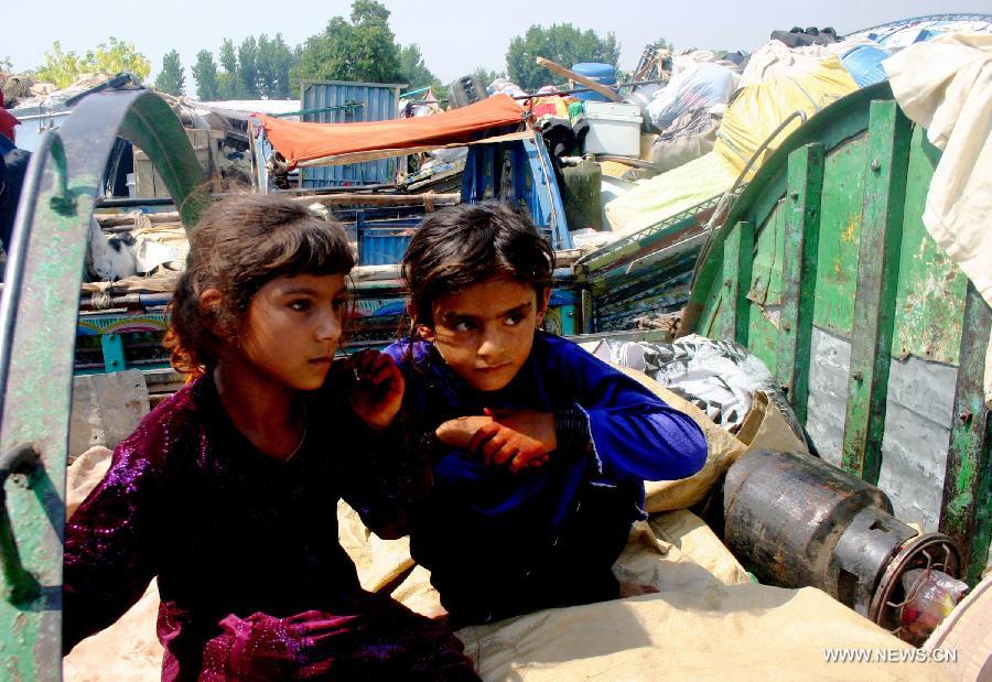 Afghan refugee girls sit on a loaded truck near the United Nations High Commissioner for Refugees (UNHCR) registration center before returning to Afghanistan in northwest Pakistan's Peshawar, on June 20, 2013. Some 45.2 million people worldwide are under forced displacement due to persecution, conflict, generalized violence and human rights violations by the end of 2012, said an annual report released by the United Nations High Commissioner for Refugees (UNHCR) Wednesday. Developing countries hosted over 80 percent of the world's refugees, compared to 70 percent a decade ago, as the report noted, with Pakistan as the country hosting the largest number of refugees worldwide. (Xinhua/Ahmad Sidique)
