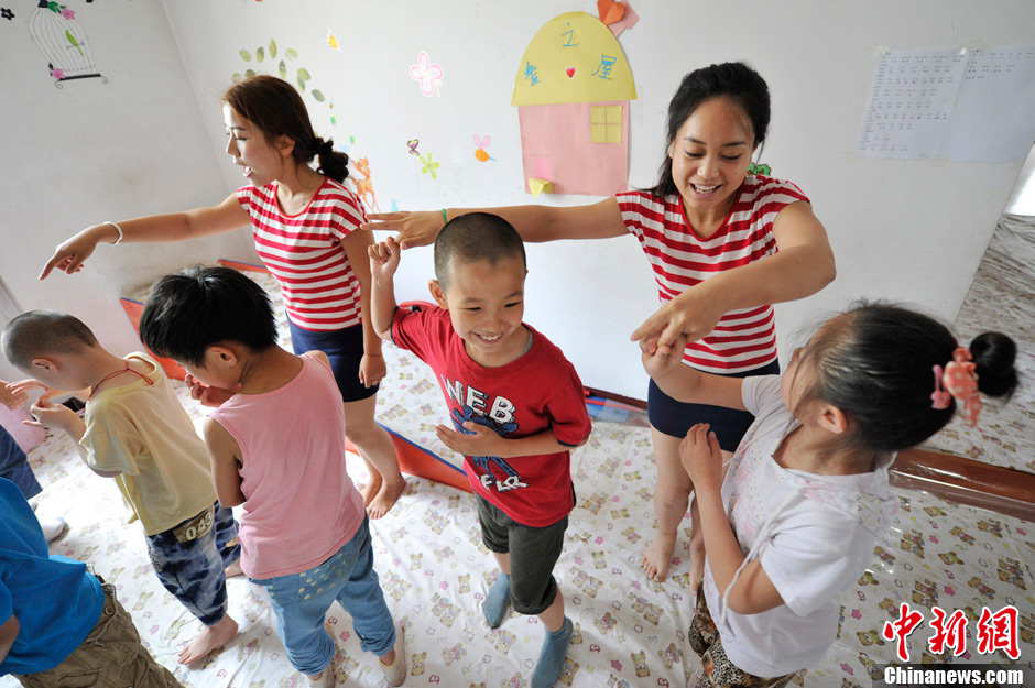 Li Xiaojiao instructs children to do rehabilitation. It has been 5 years since Li established the non-profit classroom specifically for children with autism in Taiyuan, north China’s Shanxi province. (Photo by Weiliang/ Chinanews.com)
