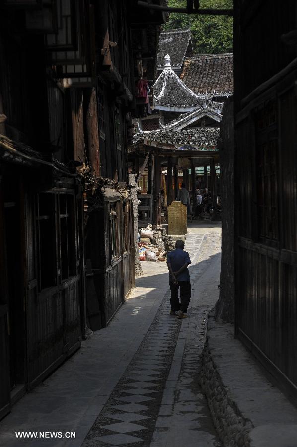 A man walks at the Zhaoxing Dong Village in Liping County, southwest China's Guizhou Province, June 20, 2013. Zhaoxing Dong Village is one of the largest Dong village in Guizhou. In 2005, it was ranked one of China's six most beautiful villages and towns by Chinese National Geography. (Xinhua/Ou Dongxu)