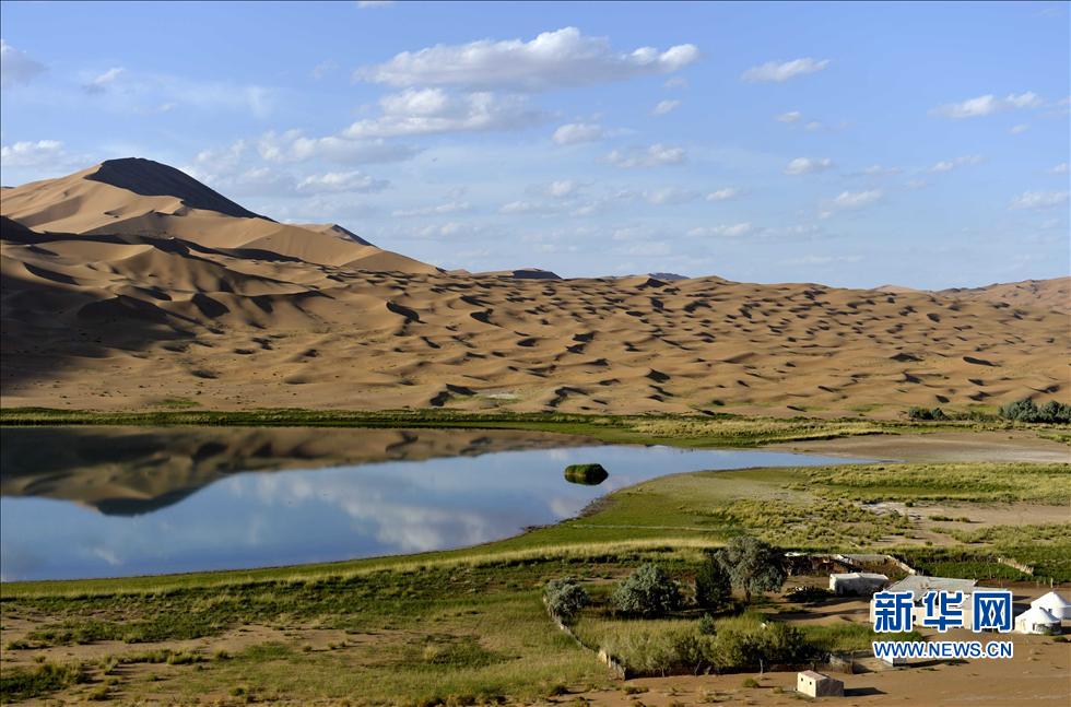 A beautiful view can be seen at a lake in the Badain Jaran Desert, North China's Inner Mongolia autonomous region, June 18, 2013. (Xinhua/Ren Junchuan)