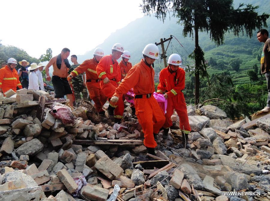 Rescuers carry an injured person at the landslide site in Fulai Village in Luzhou City, southwest China's Sichuan Province, June 22, 2013. Four people were confirmed dead and three others injured in a rainstorm-triggered landslide that hit Fulai Village early Saturday morning, according to the local government. (Xinhua/Deng Liangkui) 