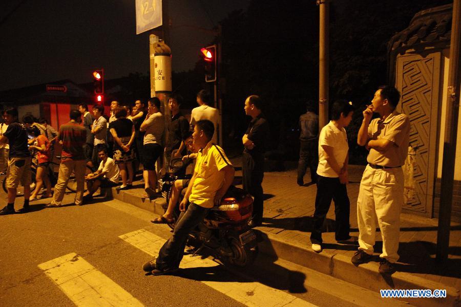 People gather at the murder site at a chemical factory in Baoshan District, east China's Shanghai Municipality, June 23, 2013. Police arrested late Saturday a 62-year-old man, surnamed Fan, who murdered six people, including four colleagues, a driver and a barracks guard in Shanghai. (Xinhua)
