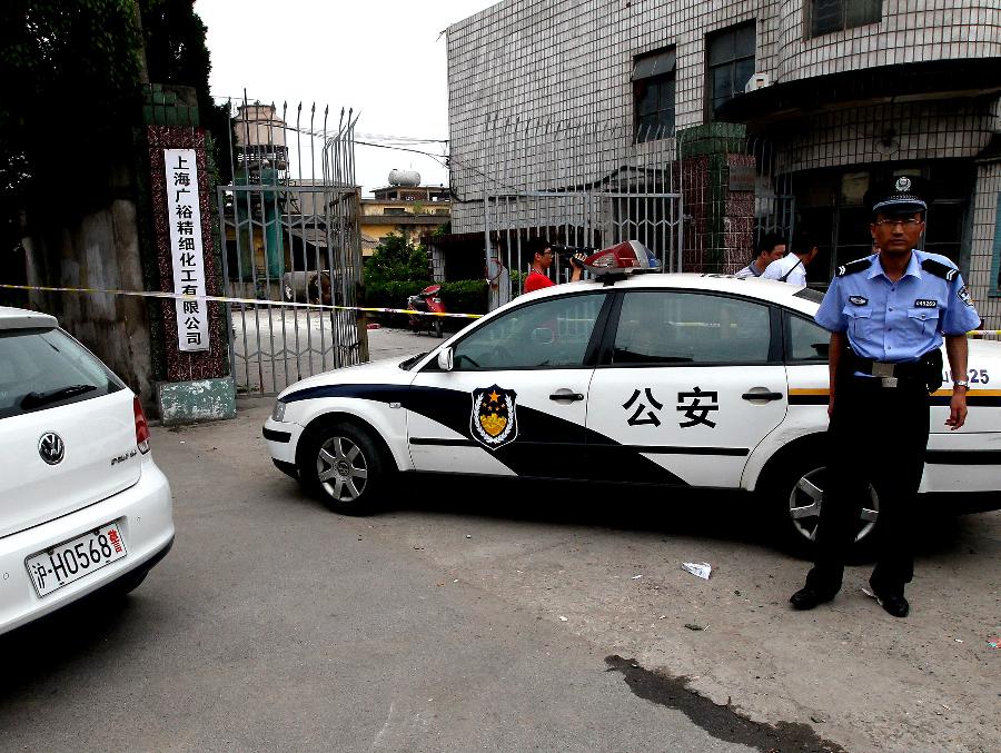 A policeman guards at the murder site at a chemical factory in Baoshan District, east China's Shanghai Municipality, June 23, 2013. Police arrested late Saturday a 62-year-old man, surnamed Fan, who murdered six people, including four colleagues, a driver and a barracks guard in Shanghai. (Xinhua/Chen Fei)