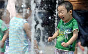 Children frolic at fountain in NE China