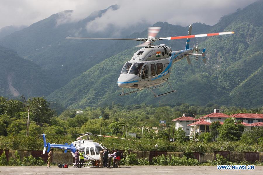 A helicopter takes off from the airport in Dehradun, northern Indian state of Uttarakhand, June 26, 2013. There are still an estimated 7000 people stranded in the flood while authorities use military planes and helicopters in the rescue in flood-ravaged northern India. (Xinhua/Zheng Huansong) 
