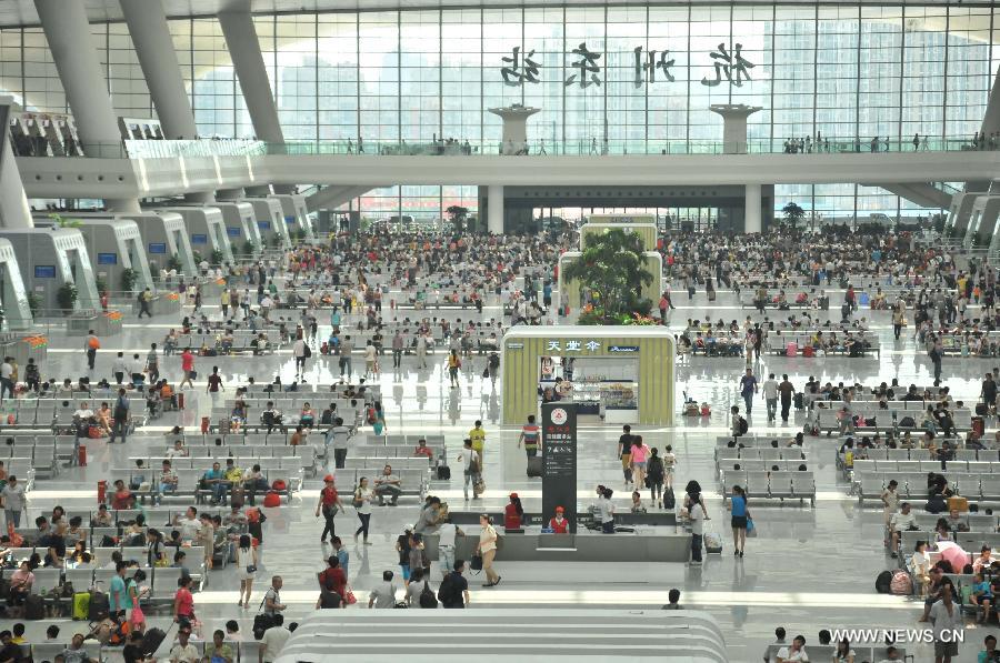 People wait for trains inside the newly-opened Hangzhou East Station in Hangzhou, capital of east China's Zhejiang Province, July 1, 2013. With the building area of 1.13 million square meters, the Hangzhou East Station, China's largest railway terminal, officially opened on Monday. (Xinhua/Zhu Yinwei) 