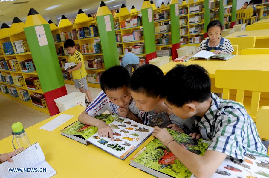 Children read books at the Henan Provincial Children's Library in Zhengzhou, capital of central China's Henan Province, July 1, 2013. Many children enjoy reading during their summer vacation. (Xinhua/Zhu Xiang) 