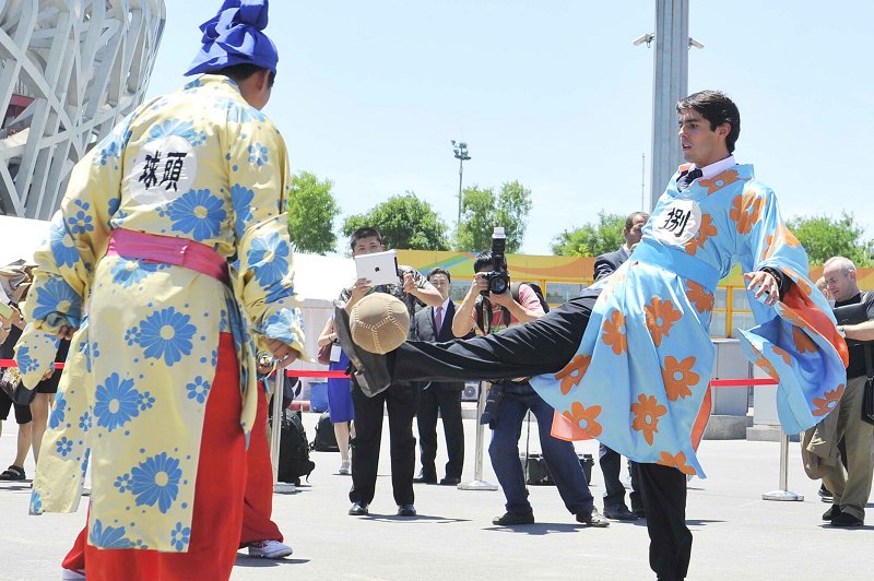 Kaka wearing "hanfu" plays "cuju" in front of  spectators in Beijing National Stadium, also known as the Bird's Nest,  in Beijing, capital of China, July 2, 2013. The Real Madrid midfielder  Kaka arrived in Beijing on Monday to promote a friendly football match  between veteran Brazilian and Chinese players. (Photo/Osports)