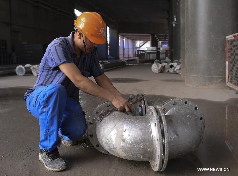 A worker dismantles a part at the construction site of the second project of the Line No.6 Beijing subway in Beijing, capital of China, July 5, 2013. The second project of the Line No.6 Beijing subway is under construction, which is expected to be put into use in 2014. (Xinhua/Wang Jianhua) 