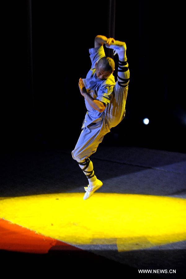 A performer of the Yandong Shaolin Kungfu troupe shows "Tongzi Kungfu" during a performance held at the Worker's Cultural Palace, Taiyuan, capital of north China's Shanxi Province, July 6, 2013. The martial art troupe have their performers trained in the renowned Shaolin Temple, and staged performances worldwide in the hope of promoting Shaolin-style martial arts and Chinese culture. (Xinhua/Fan Minda)  