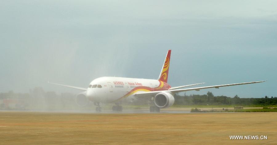 A Boeing 787 Dreamliner lands at the Haikou Meilan International Airport in Haikou, capital of south China's island of Hainan Province, July 7, 2013. Haian Airlines held a ceremony here to welcome the arrival of its first Boeing 787 Dreamliner. Mou Wei, vice president of Hainan Airlines, said on July 4 that the first 213-seat Dreamliner will serve the domestic route between Beijing and Haikou, capital of south China's Hainan Province, with 36 seats reserved for business class and 177 for economy. (Xinhua/Zhao Yingquan) 